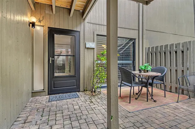 a view of a hallway with wooden floor and dining room view