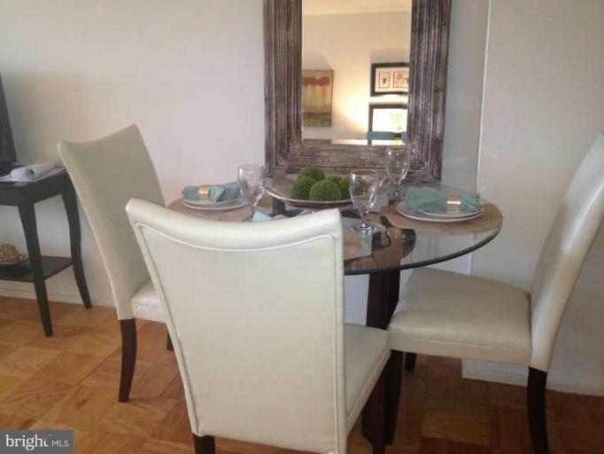 1311 Delaware Avenue Southwest, Unit S145 Washington, DC 20024 - Photo 4 of 9 a dining room with furniture and window