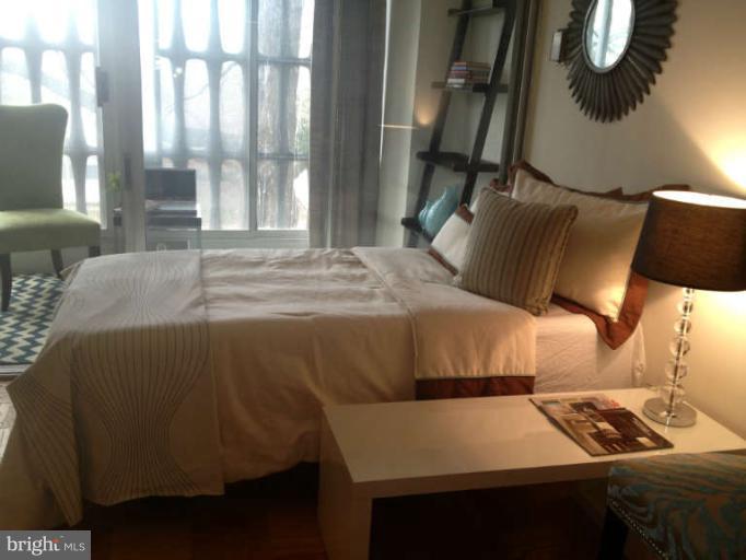 1311 Delaware Avenue Southwest, Unit S145 Washington, DC 20024 - Photo 6 of 9 a bedroom with a bed and a window