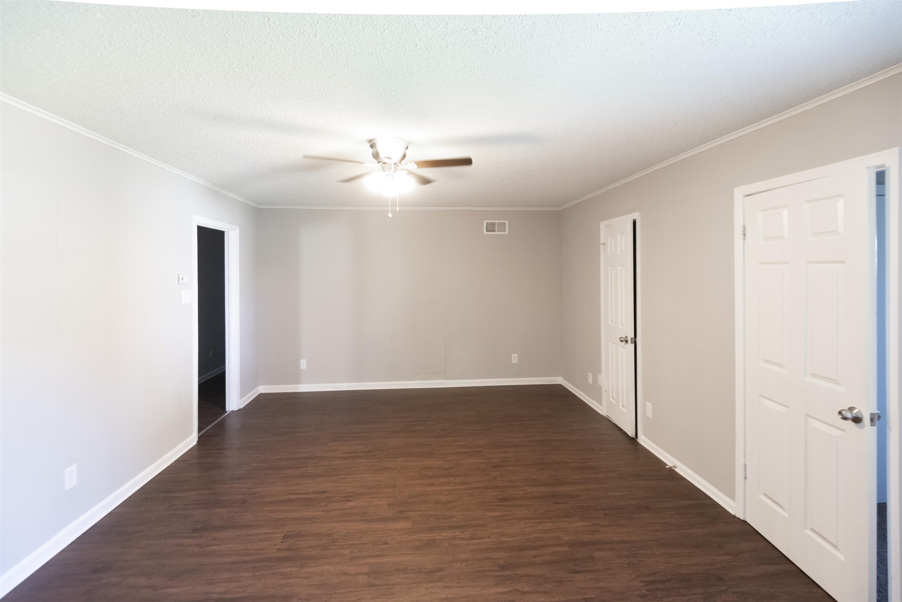 4399 Pepper Tree Road Memphis, TN 38109 - Photo 8 of 14 Wood-finish flooring with light gray walls, white trim, and a ceiling fan with integrated lighting
