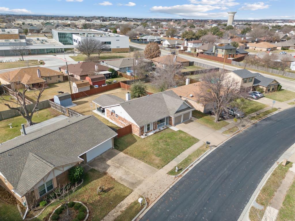 7629 Cedarhill Road Watauga, TX 76148 - Photo 32 of 33 Aerial perspective showcasing a residential neighborhood with single-story homes, asphalt streets, and mature trees