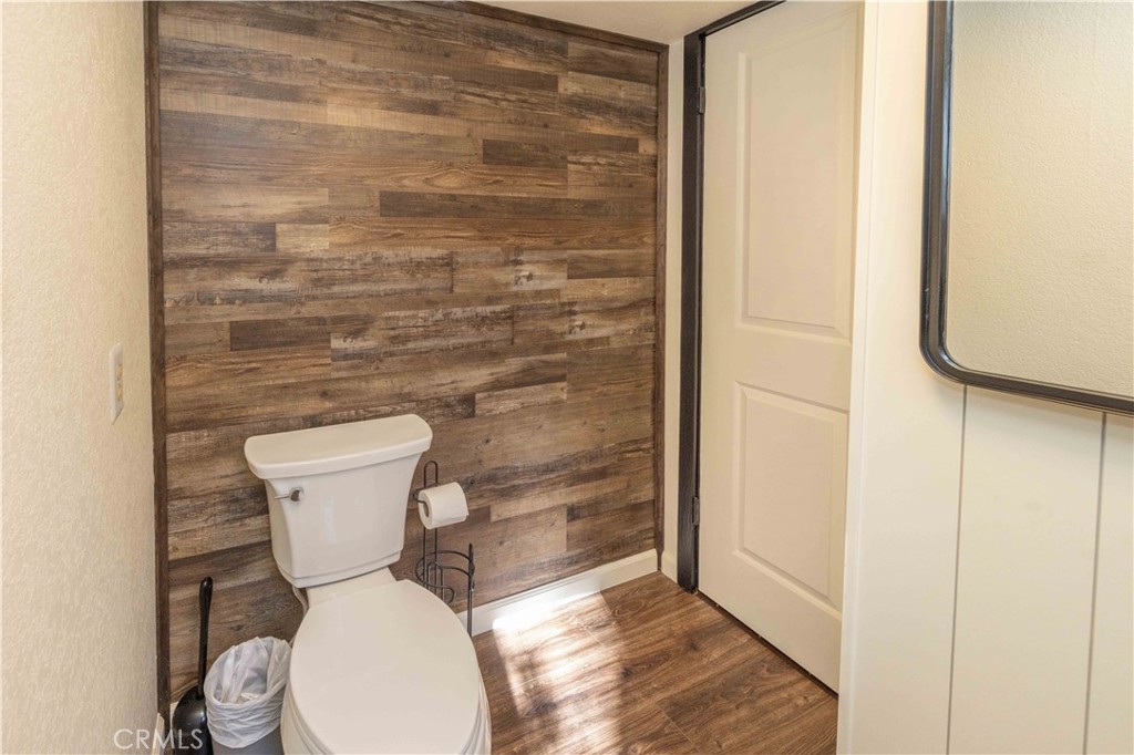 1107 Cedar Mountain Road Big Bear City, CA 92314 - Photo 19 of 42 a white toilet sitting next to a shower curtain