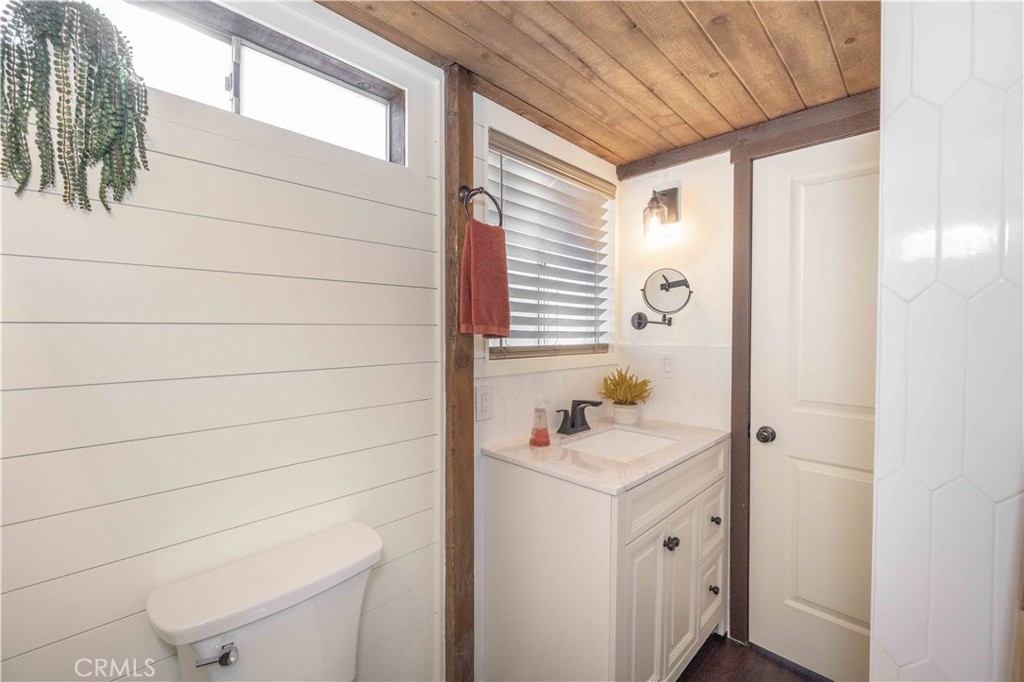 1107 Cedar Mountain Road Big Bear City, CA 92314 - Photo 26 of 42 a bathroom with a sink toilet and shower