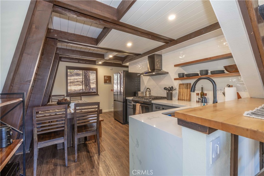 1107 Cedar Mountain Road Big Bear City, CA 92314 - Photo 7 of 42 a kitchen with sink a stove and chairs