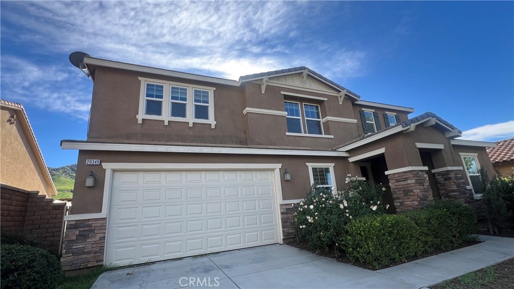 a front view of a house with garage