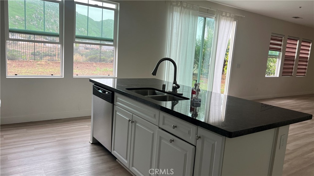 20349 Barrel Road Riverside, CA 92507 - Photo 11 of 21 a kitchen with granite countertop a sink and a wooden floor