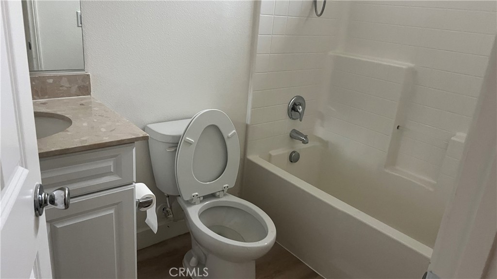 20349 Barrel Road Riverside, CA 92507 - Photo 8 of 21 a bathroom with a granite countertop toilet and a bathtub