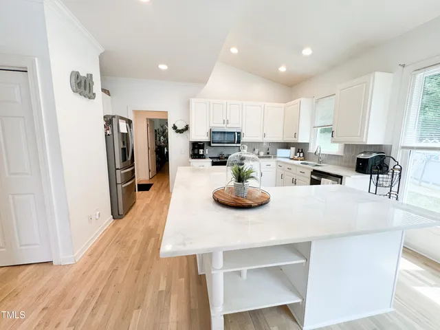 a view of kitchen with cabinets table and chairs