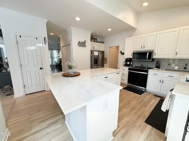 a kitchen with a stove a refrigerator and a sink