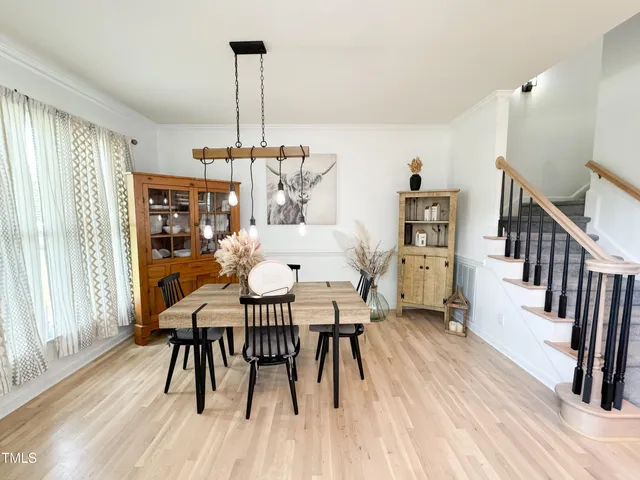 a view of hallway with wooden floor and stairs