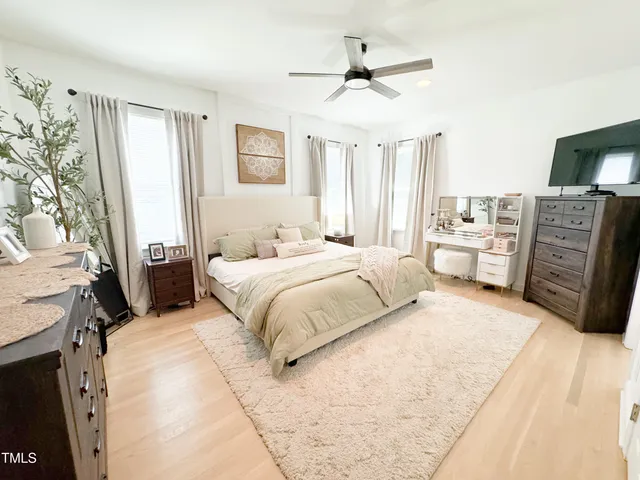 a bedroom with a large bed and a window