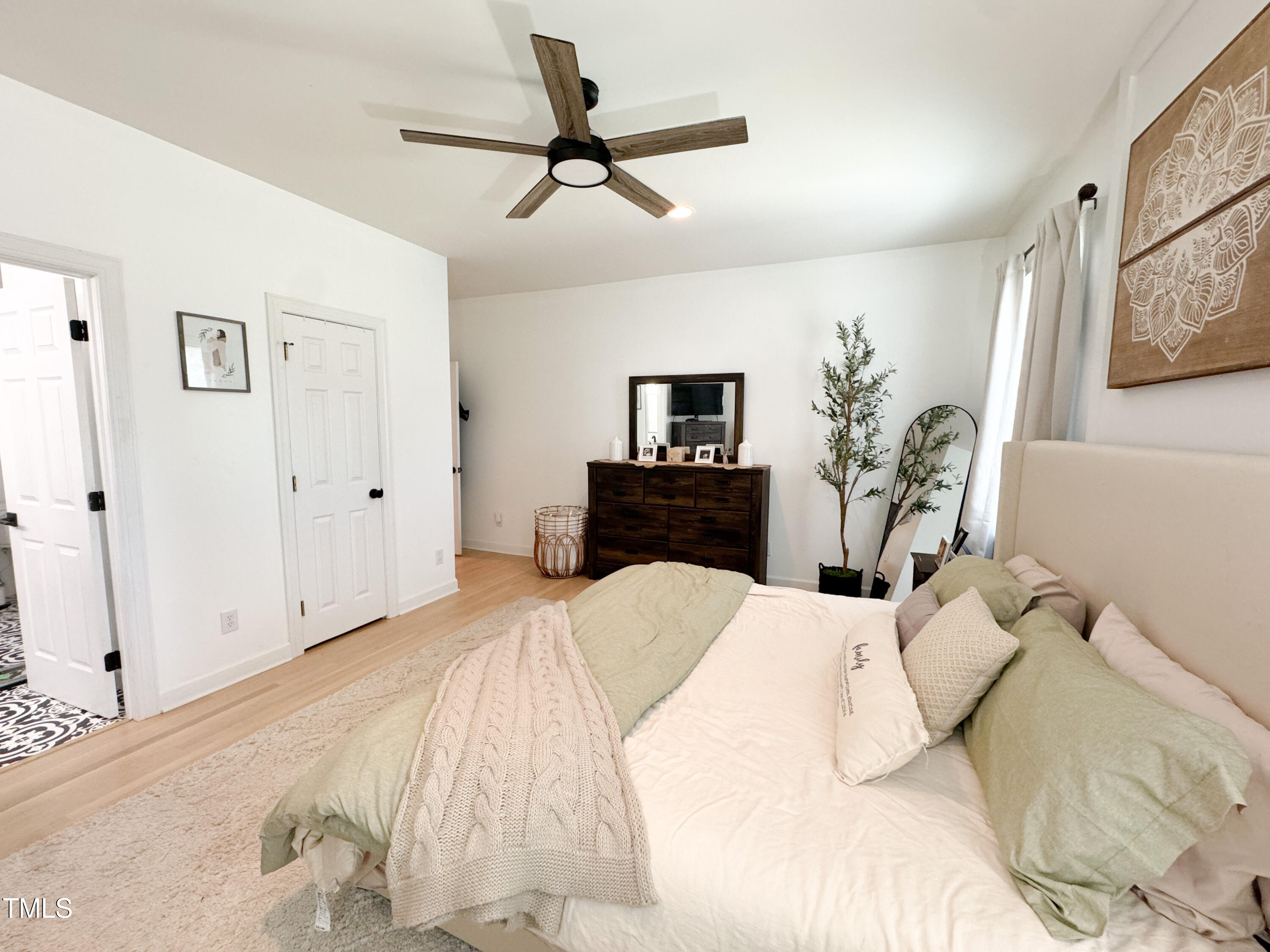 120 Denada Path Roxboro, NC 27574 - Photo 24 of 44 a bedroom with a bed a chandelier and a potted plant on the dresser