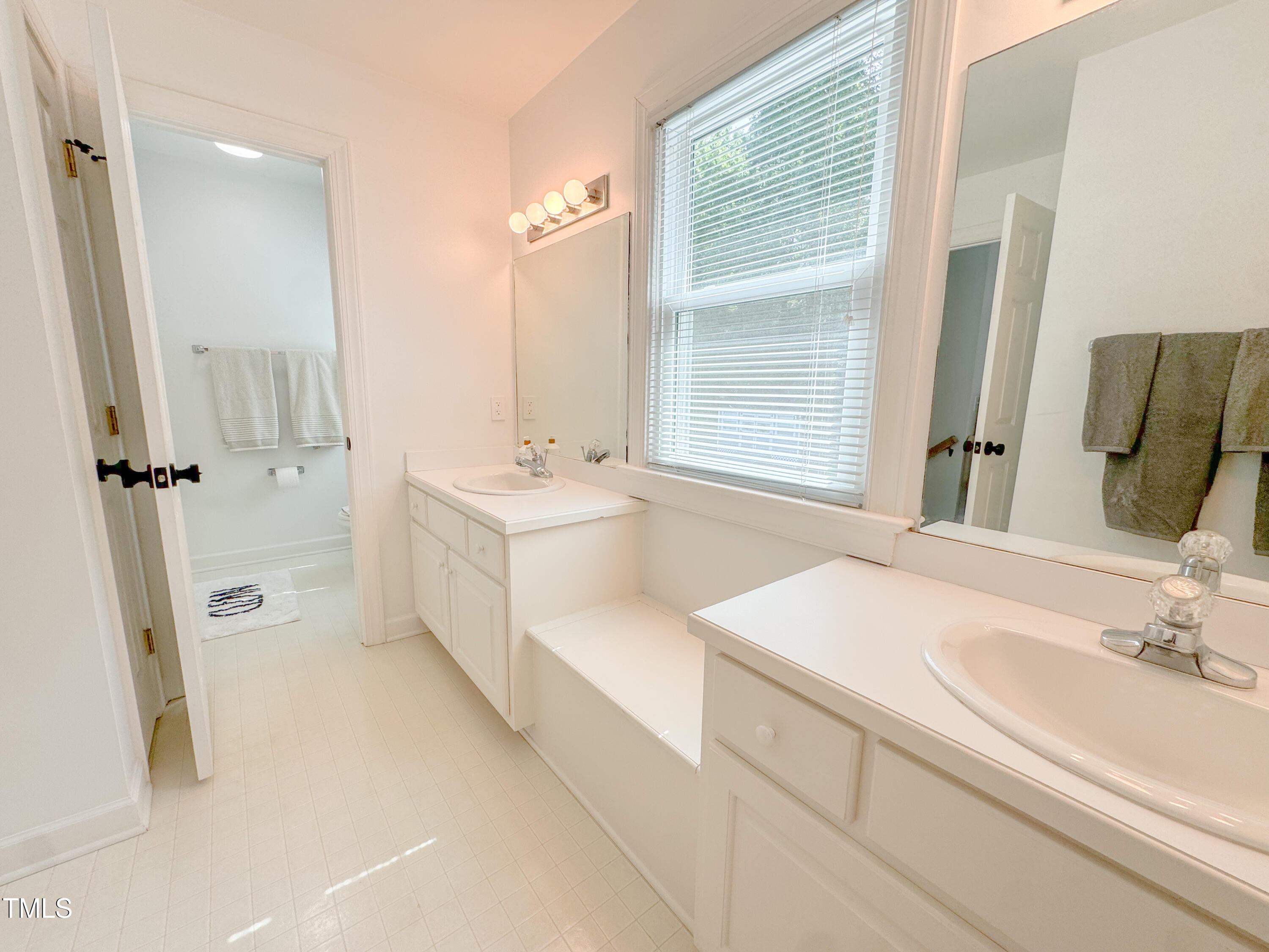 120 Denada Path Roxboro, NC 27574 - Photo 31 of 44 a bathroom with a sink a tub and a mirror