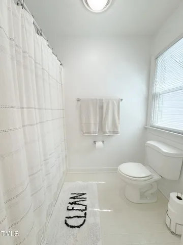 a bedroom with a bed window and walk in closet