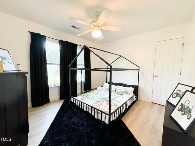 a bedroom with two beds and a chandelier