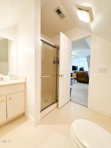 a view of a house with a big yard and large tree