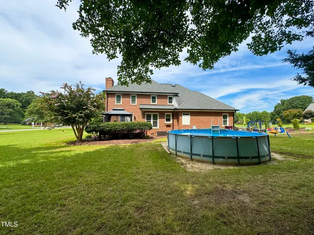 an aerial view of a house with a swimming pool