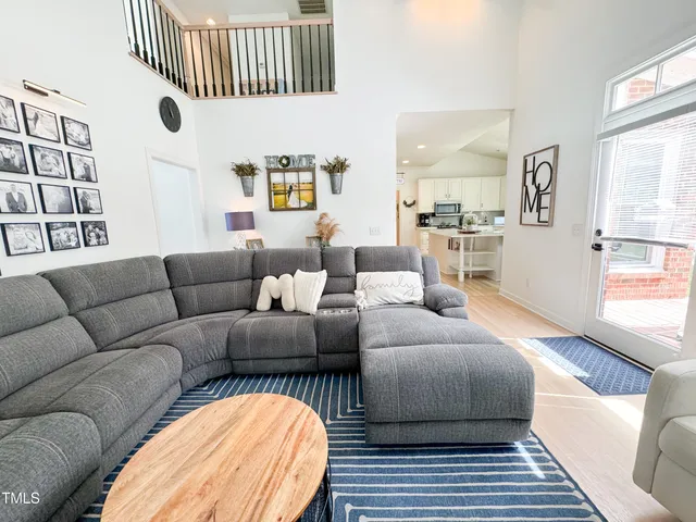 a living room with furniture a rug and a window
