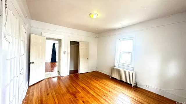 a view of a room with wooden floor and windows