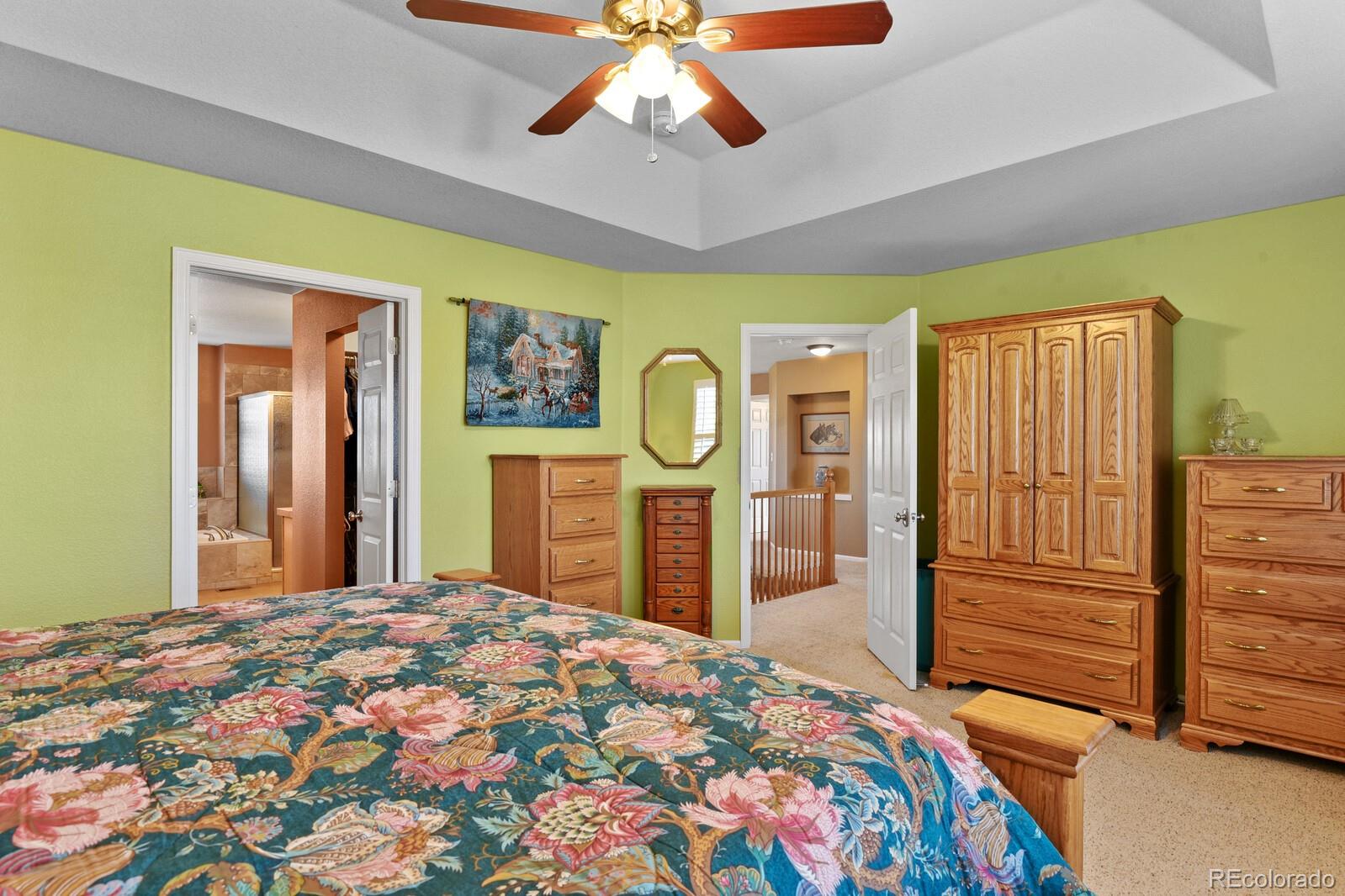 10144 Spring Water Court Highlands Ranch, CO 80129 - Photo 14 of 40 a bedroom with a bed dresser and a large window