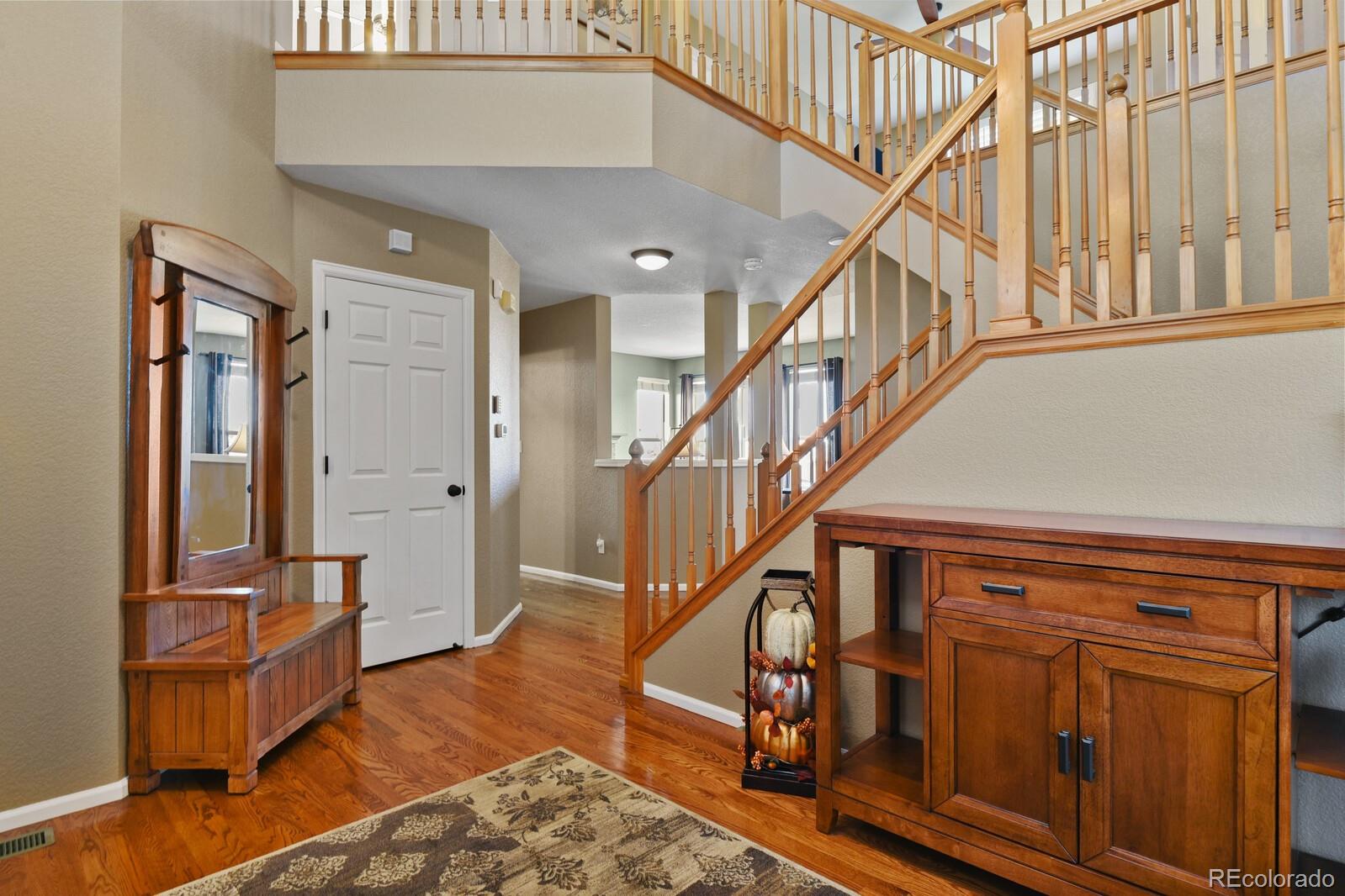 10144 Spring Water Court Highlands Ranch, CO 80129 - Photo 2 of 40 a view of entryway with wooden floor and a front door