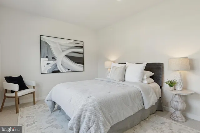 a bedroom with a bed and a painting on the wall