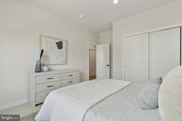 a bedroom with a bed and a dresser