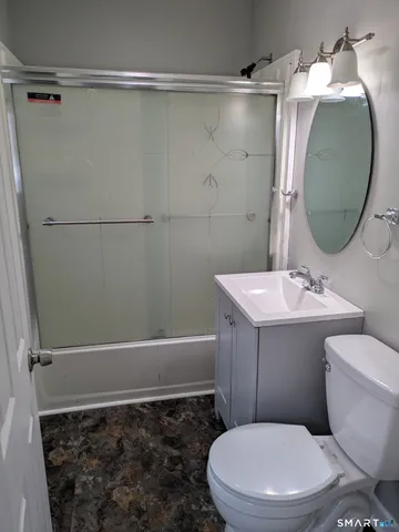 a bathroom with a toilet a sink and bathtub