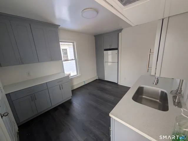 a kitchen with sink and cabinets