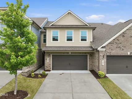 a front view of a house with garage