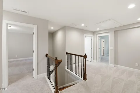 a view of a hallway with a livingroom and entryway