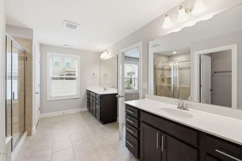 a spacious bathroom with a sink double vanity and a mirror