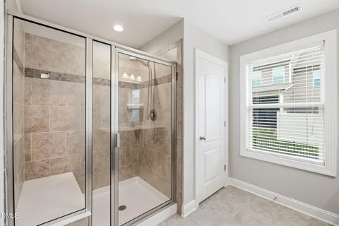 a bathroom with a glass shower door