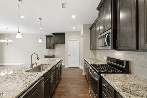 a kitchen with granite countertop stainless steel appliances and sink