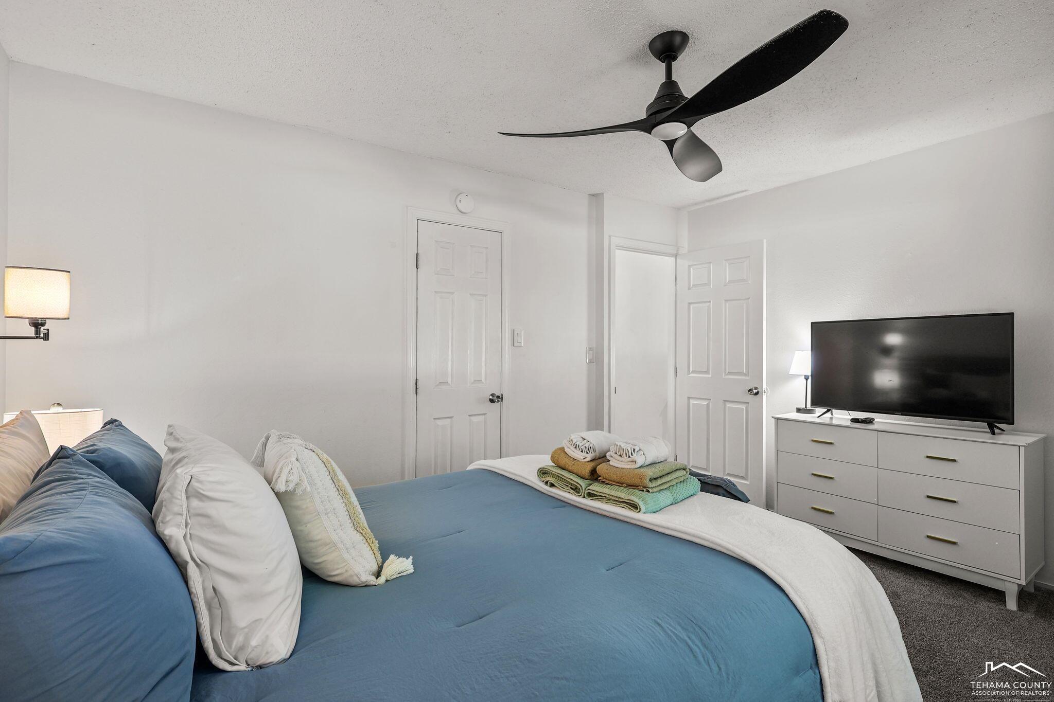 22275 Brent Road Red Bluff, CA 96080 - Photo 15 of 47 a bedroom with a bed and a flat screen tv