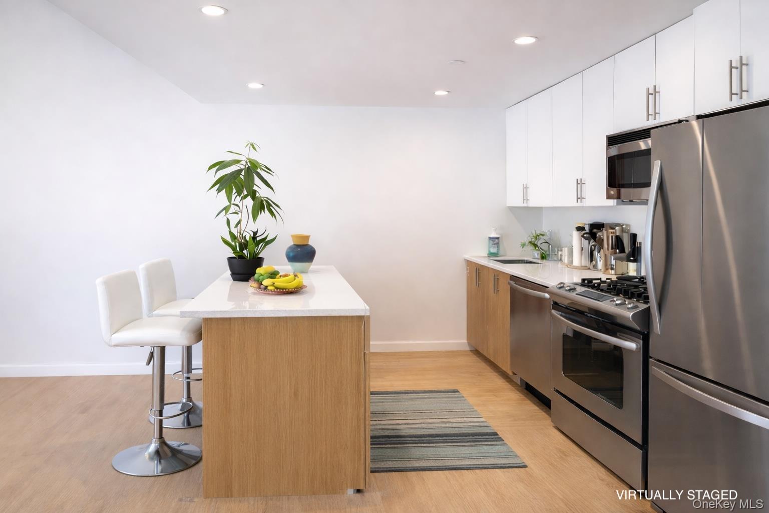 112-02 Northern Boulevard, Unit 2B Queens, NY 11368 - Photo 3 of 13 a kitchen with stainless steel appliances granite countertop a refrigerator and a stove