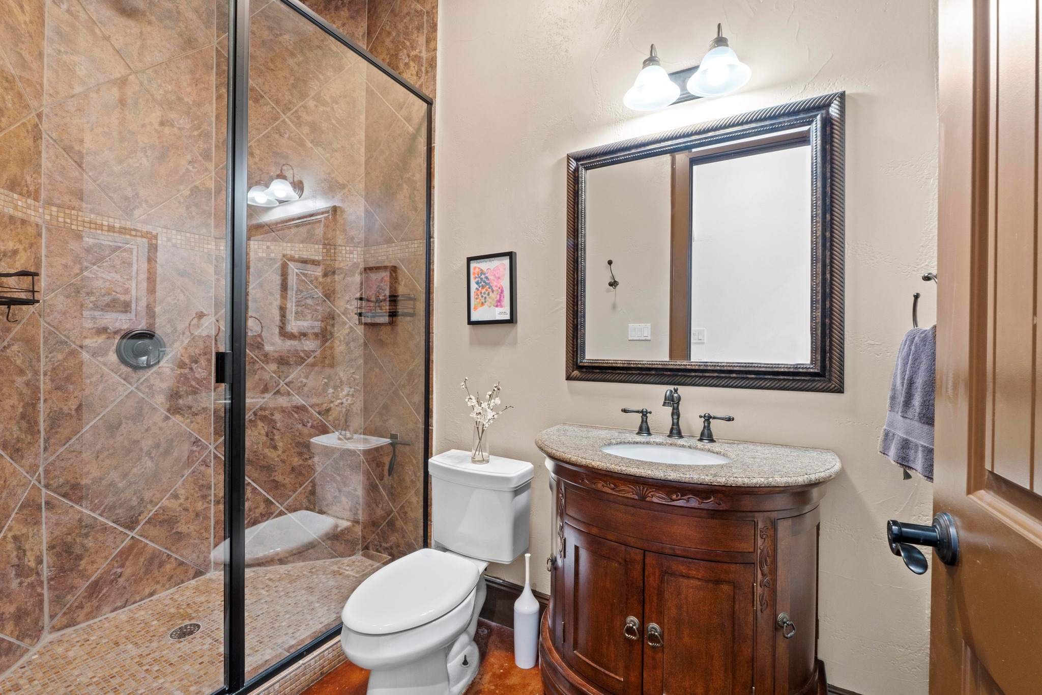 8211 Moon Rise Trail Jonestown, TX 78645 - Photo 10 of 34 Downstairs full bathroom featuring toilet, a stall shower, and vanity.