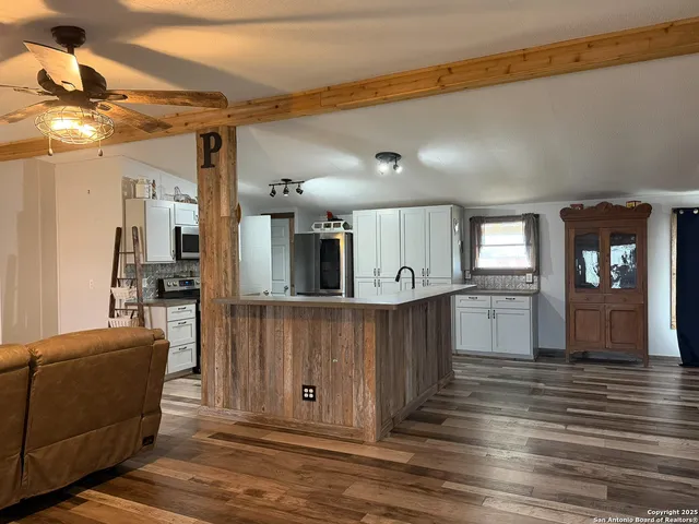 a view of kitchen with cabinets and wooden floor