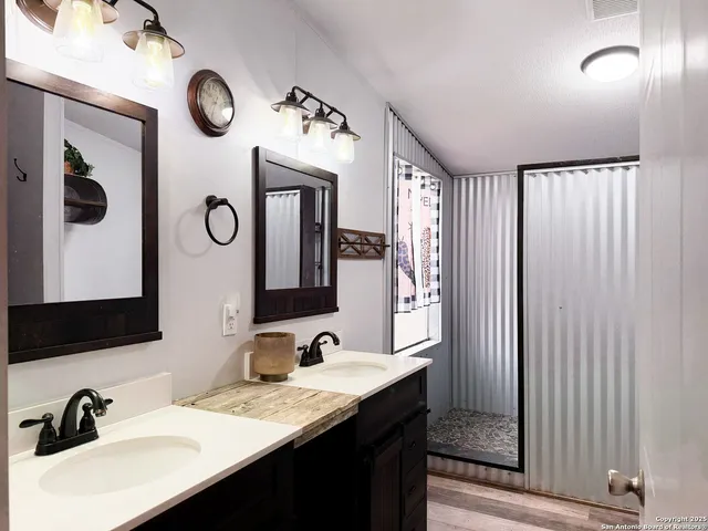 a bathroom with a double vanity sink and mirror