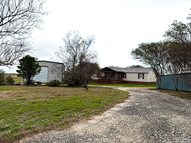a house that has a big yard with large trees