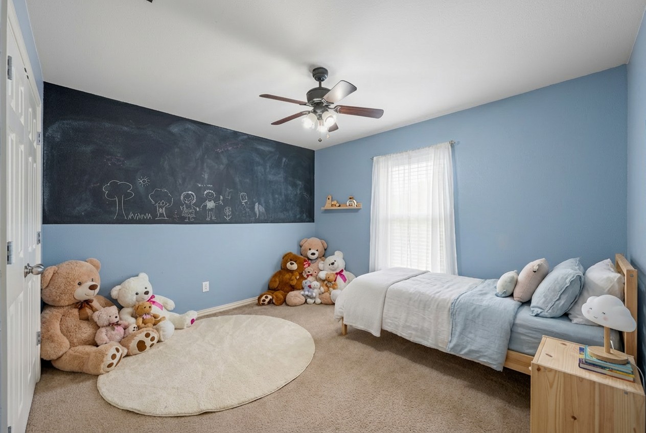 2415 Elkhorn Ranch Road Leander, TX 78641 - Photo 18 of 39 a bedroom with a bed and a chandelier