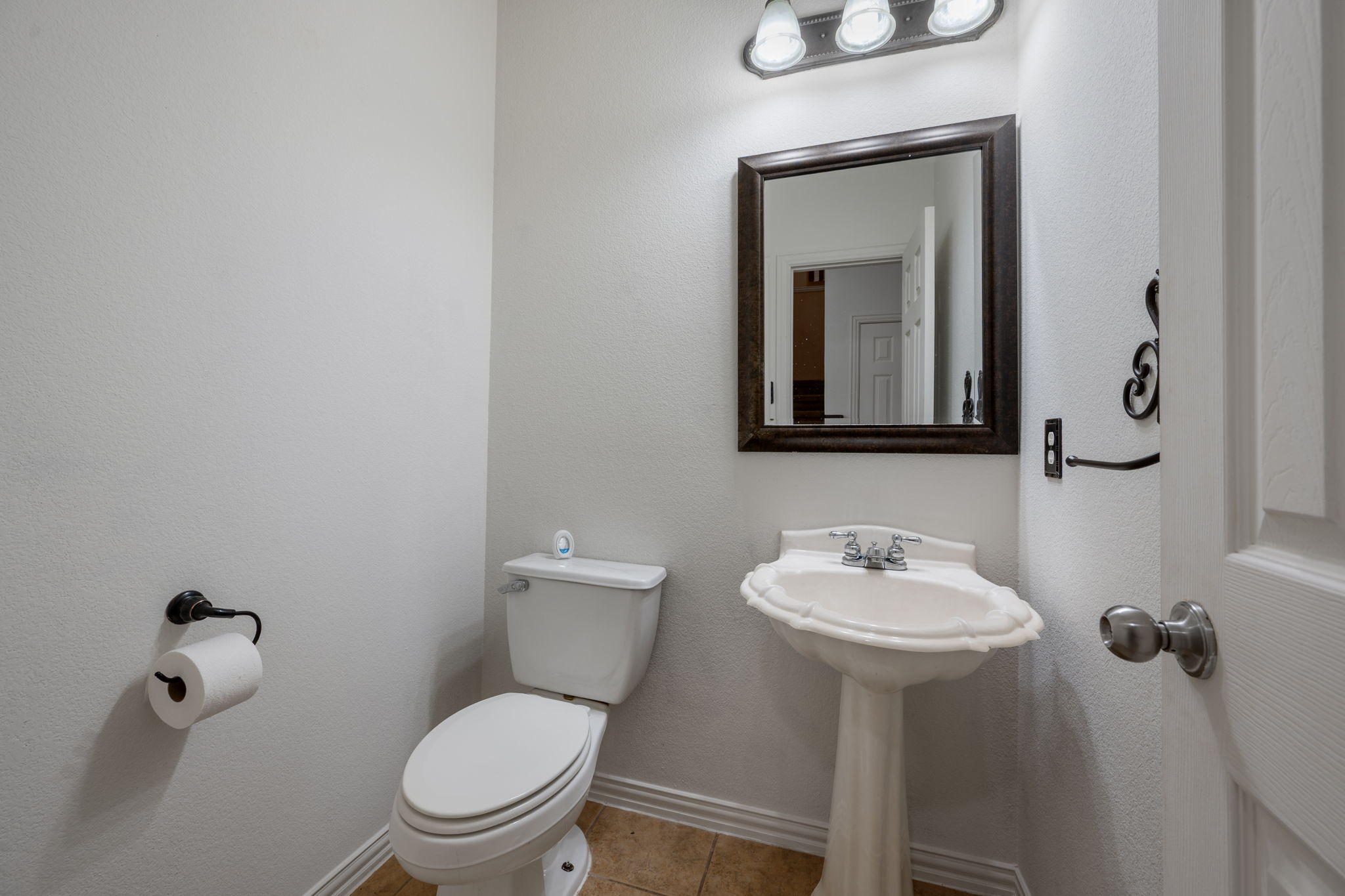 2415 Elkhorn Ranch Road Leander, TX 78641 - Photo 23 of 39 a bathroom with a toilet sink and mirror