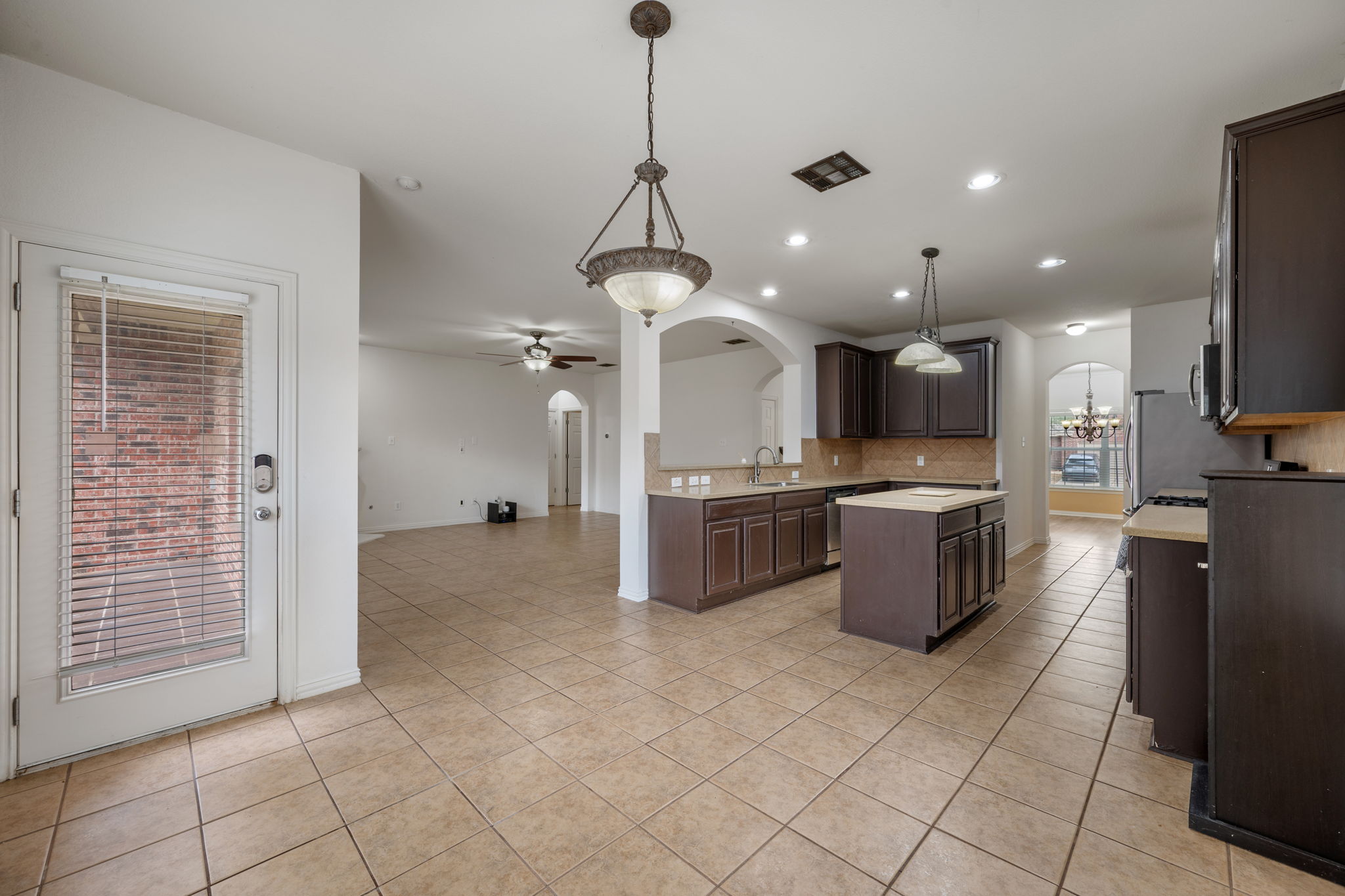 2415 Elkhorn Ranch Road Leander, TX 78641 - Photo 38 of 39 a kitchen with stainless steel appliances kitchen island granite countertop a sink and cabinets