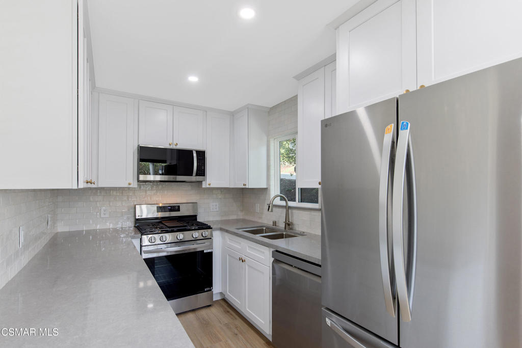 313 Raymond Street, Unit A Ojai, CA 93023 - Photo 5 of 32 a kitchen with stainless steel appliances granite countertop a refrigerator stove and microwave