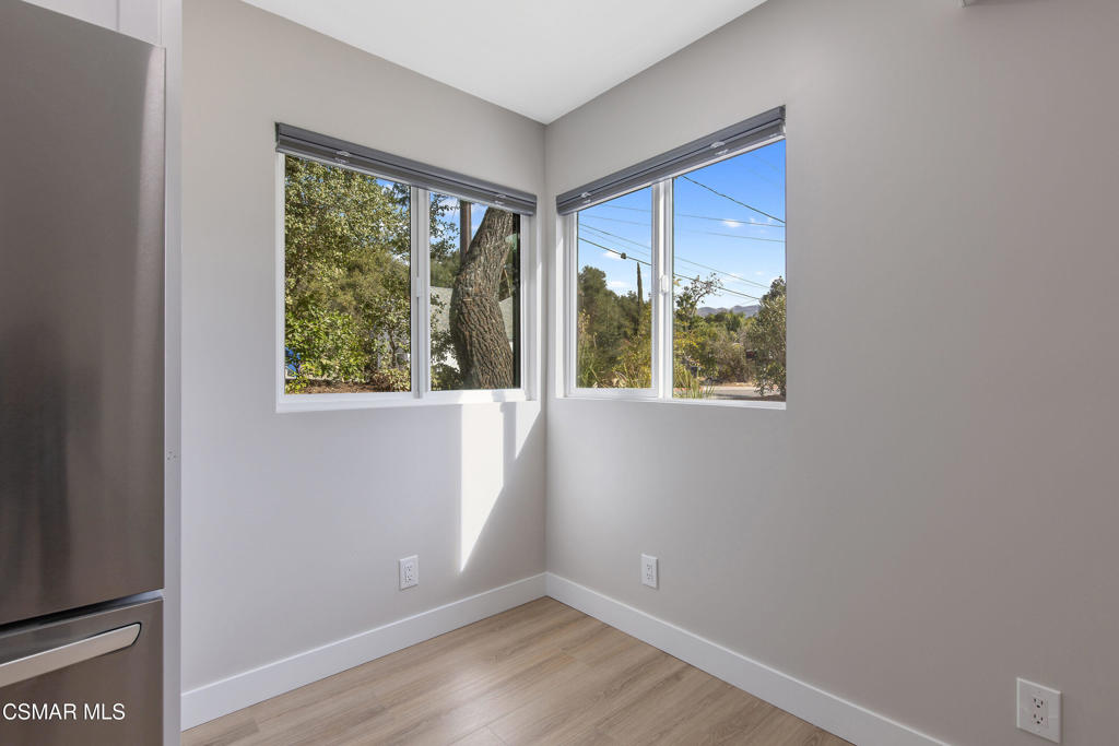 313 Raymond Street, Unit A Ojai, CA 93023 - Photo 8 of 32 a view of an empty room with wooden floor and a window