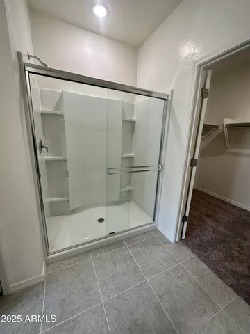 a bathroom with a glass door shower