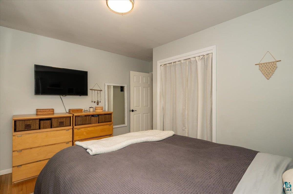606 Maple Bend Drive Duluth, MN 55811 - Photo 13 of 30 Bedroom featuring wood finished floors and a closet