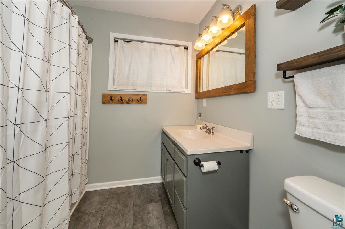 606 Maple Bend Drive Duluth, MN 55811 - Photo 18 of 30 Full bath featuring baseboards, toilet, and vanity