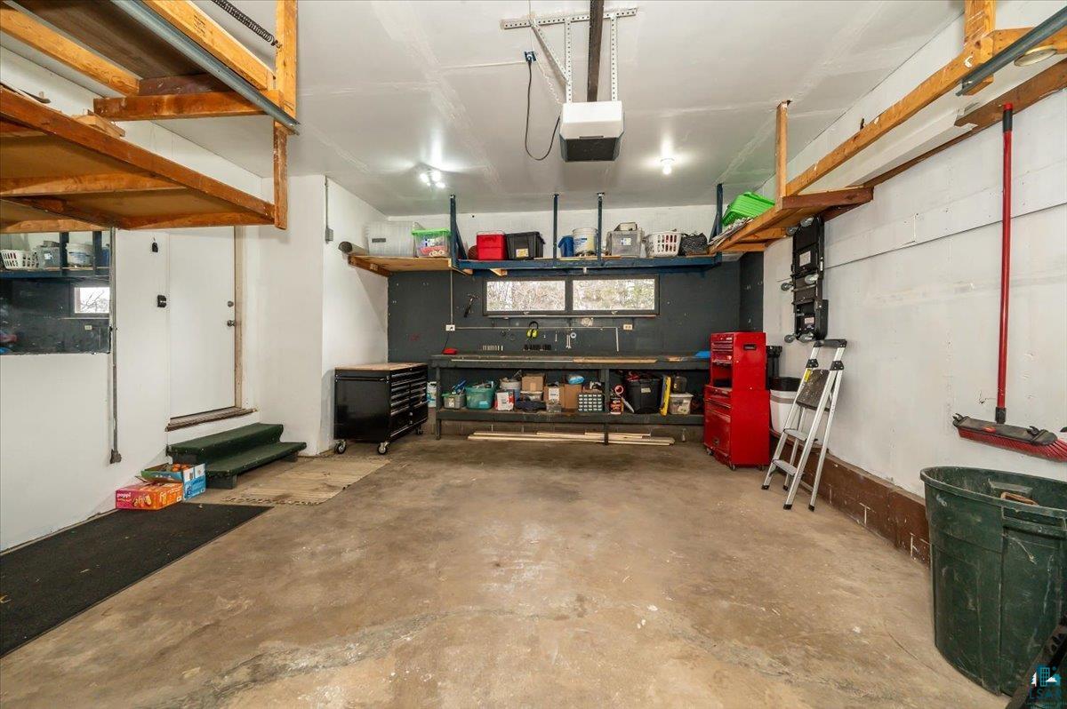 606 Maple Bend Drive Duluth, MN 55811 - Photo 23 of 30 Garage featuring a garage door opener and a workshop area