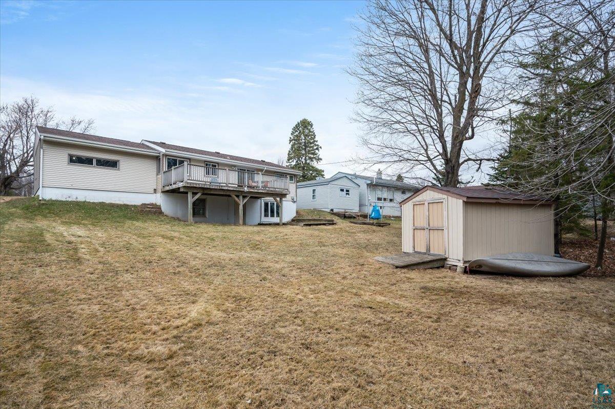 606 Maple Bend Drive Duluth, MN 55811 - Photo 28 of 30 Back of property featuring a yard, a shed, and a wooden deck